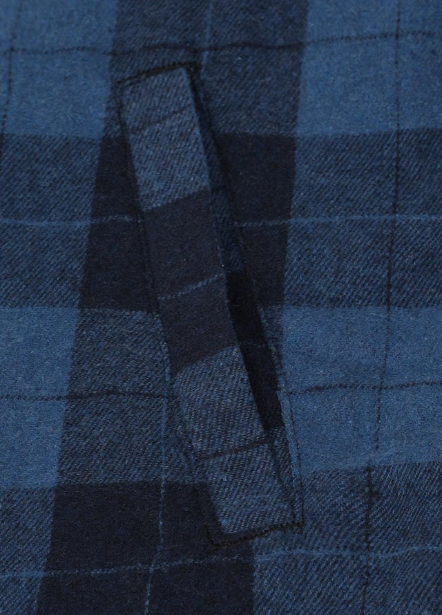 Zoomed-in view of the hand pocket on a womens black and blue flannel hooded