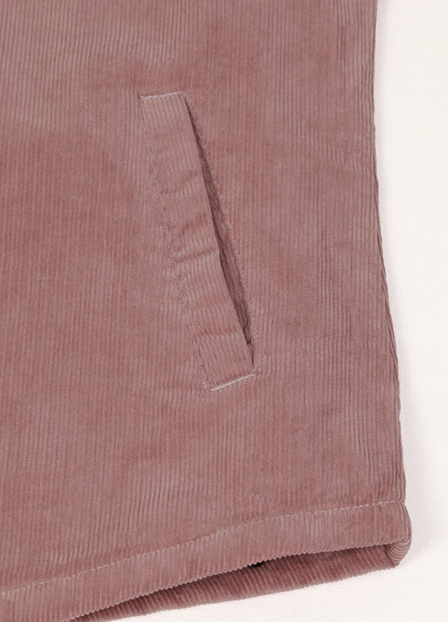 Zoomed-in view of the side hand pockets on a women's pink corduroy jacket