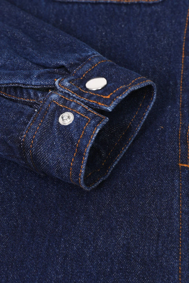 Zoomed-in view of women's dark blue flannel-linnig jean shirt jacket cuffs