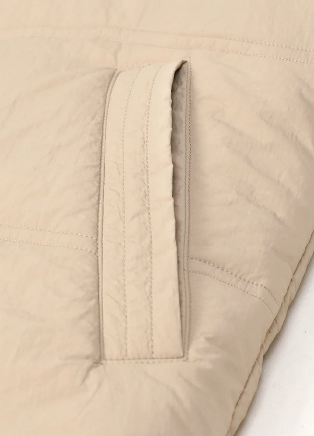 Zoomed-in view of women's khaki winter warm puffer vest side pocket