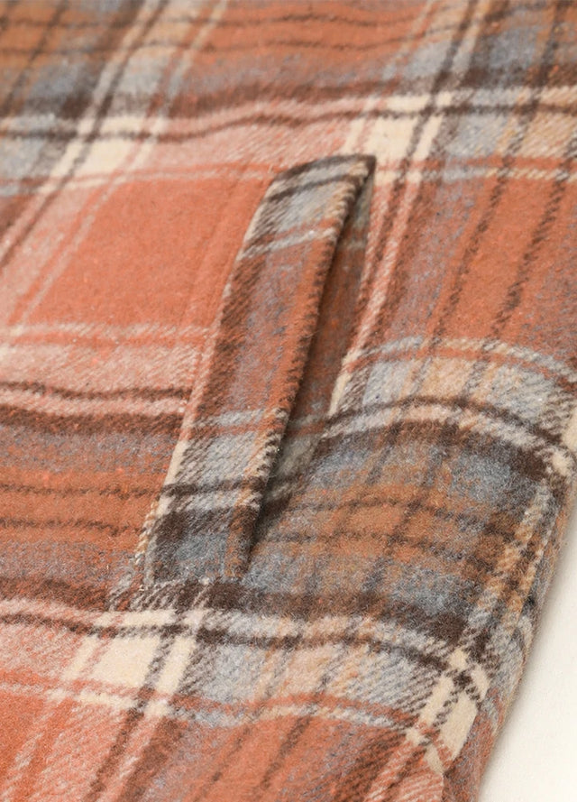 Zoomed-in view of women's orange winter plaid vest hand pocket