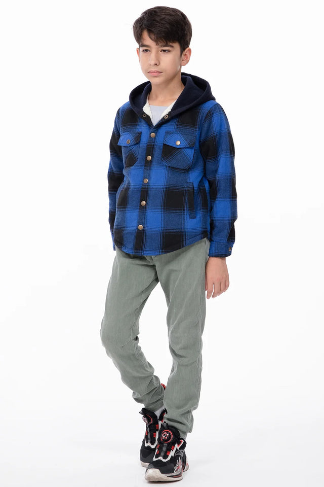 A boy with one hand in his pocket, wearing a blue black toddler flannel hoodie