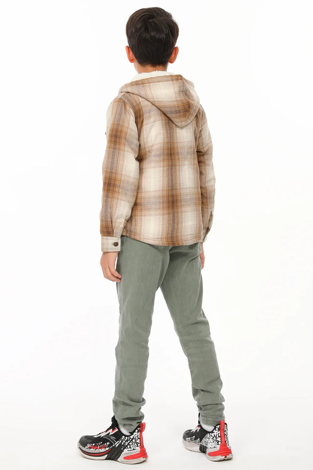 A boy in khaki flannel jacket with his back to the camera