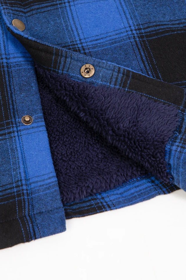 Close-up of the snap button of black blue hooded plaid flannel shirt jacket