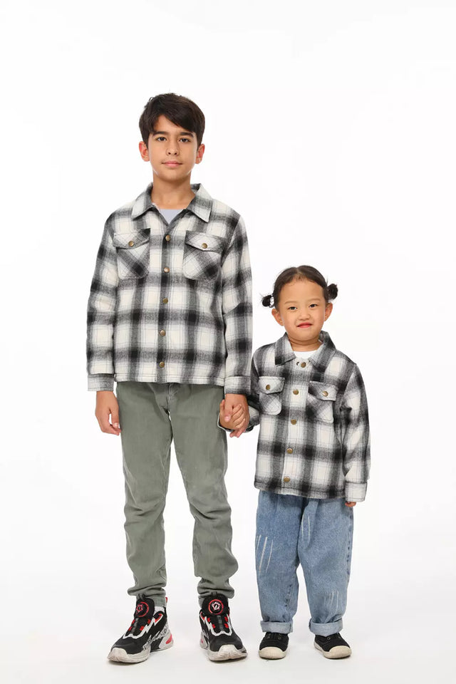 Two children in white and black toddler sherpa lined flannel plaid shacket