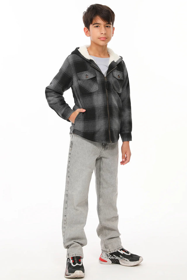 A boy with one hand in pocket in sherpa lined flannel jacket