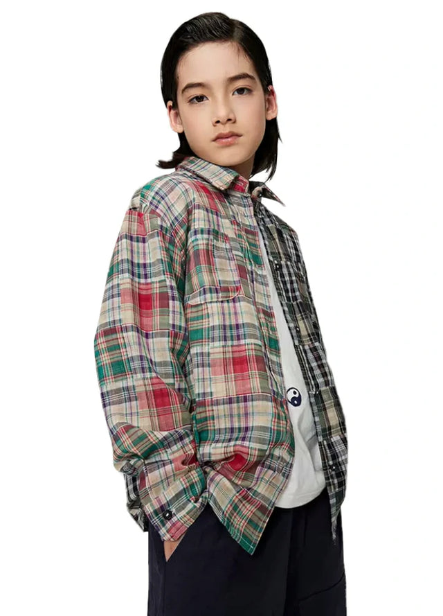 Side view of boy wearing a classic multicolor and black-and-white patchwork flannel plaid shirt