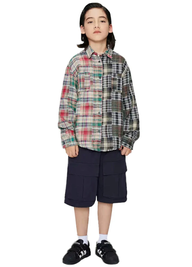 Boy who wears a classic multicolor and black-and-white patchworkflannel shirt with red and black stitching