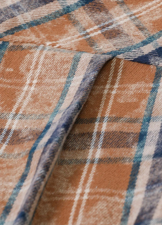 Close-up of a blue and brown men's acid plaid flannel shirt with double back pleats