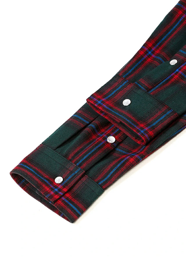 Close-up of the cuff of green red men's plaid long sleeve western shirt