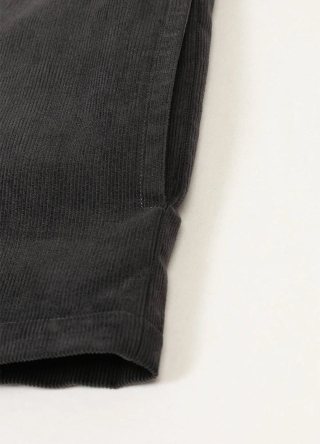 Detail of inside pocket on men's dark grey corduroy shirt jacket