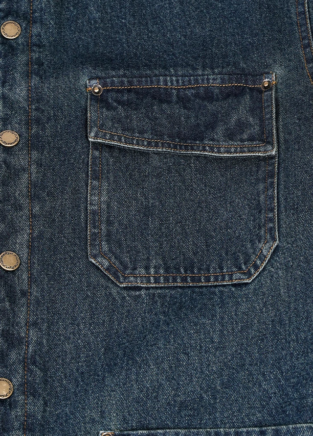 Close-up of the pocket of indigo men's classic denim flannel lined shirt jacket