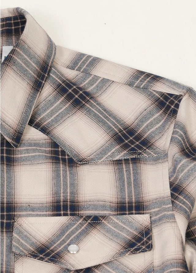 Close-up of the shoulder of beige gray men's plaid long sleeve western shirt