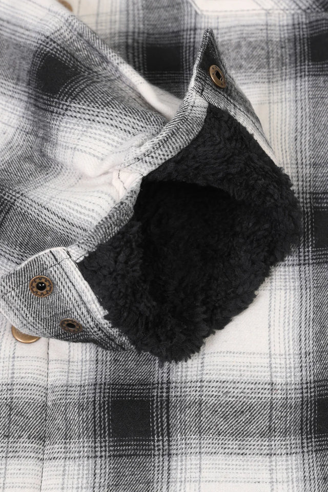 Detailed view of the cuff of white and black men's thick flannel cotton jacket with sherpa lining