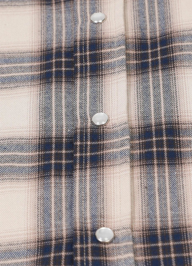 Close-up of the snap button of beige gray plaid long sleeve western shirt for men