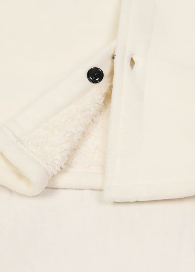 Close-up of the hem of the solid white men's cozy button up fleece jacket