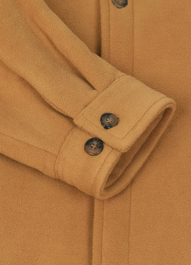 Close-up of the cuff of a yellow fleece lined plaid shirt jacket for men