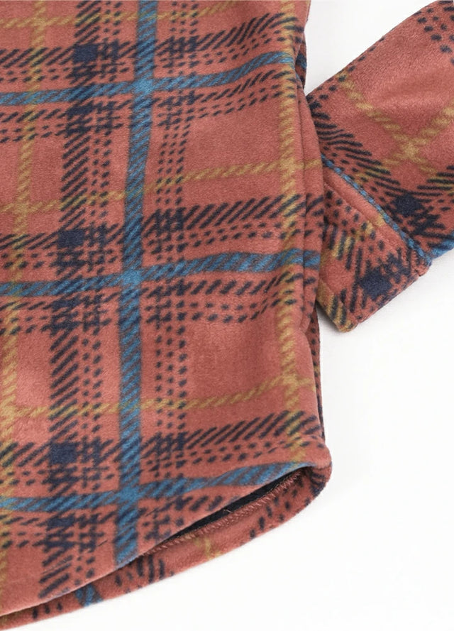 Detailed view of the handpocket of a red and blue warm men's sherpa lined shirt jacket