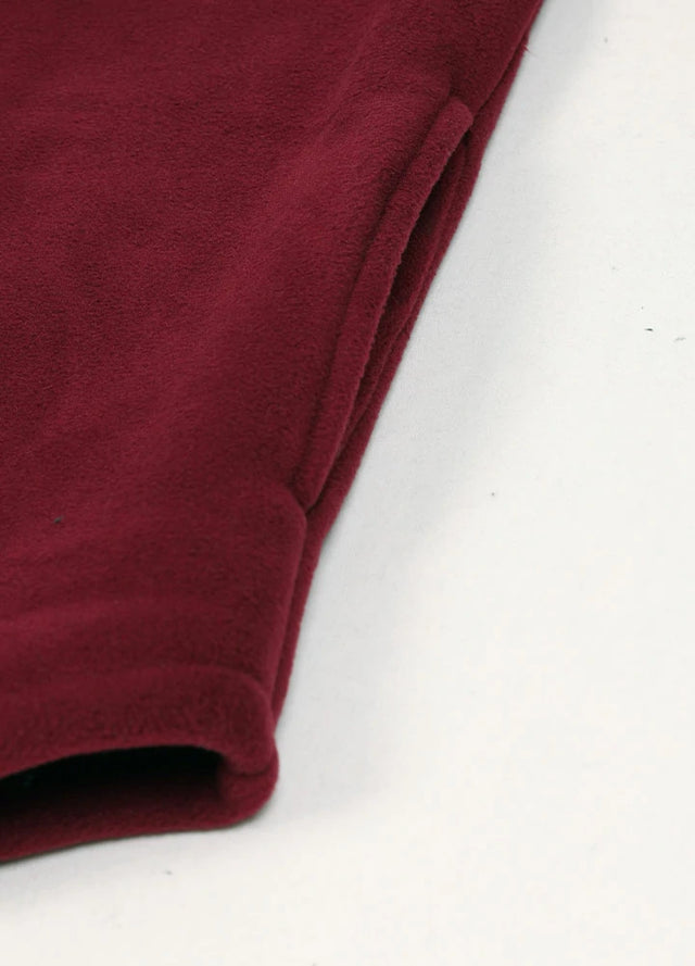 Close up of the seam pocket of dark red men's button up sherpa lined jacket