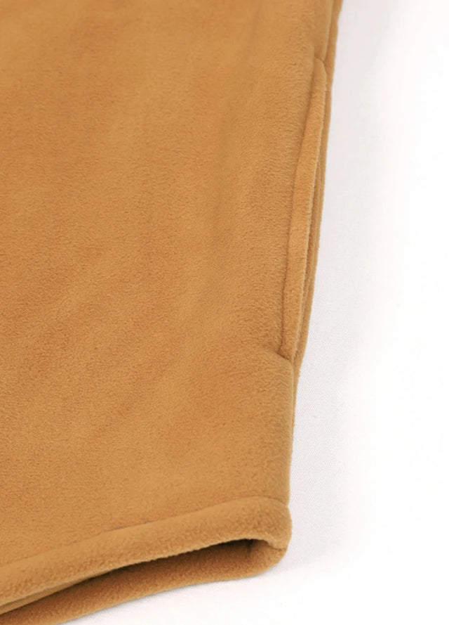 Detailed view of the seam pocket of a yellow fleece lined plaid shirt jacket for men