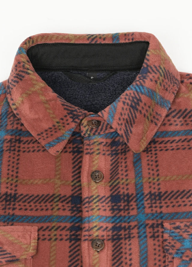 Detailed view of the lapel of the red and blue cozy men's sherpa lined shirt jacket