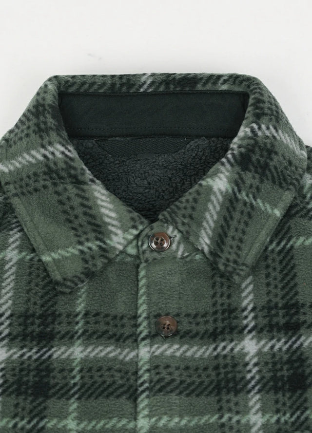 Detailed view of the lapel of the green gray cozy men's plaid shirt jacket