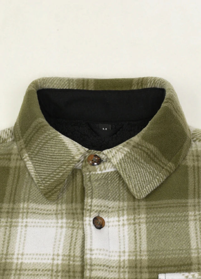 Front view of the lining of light green white men's button down plaid shacket