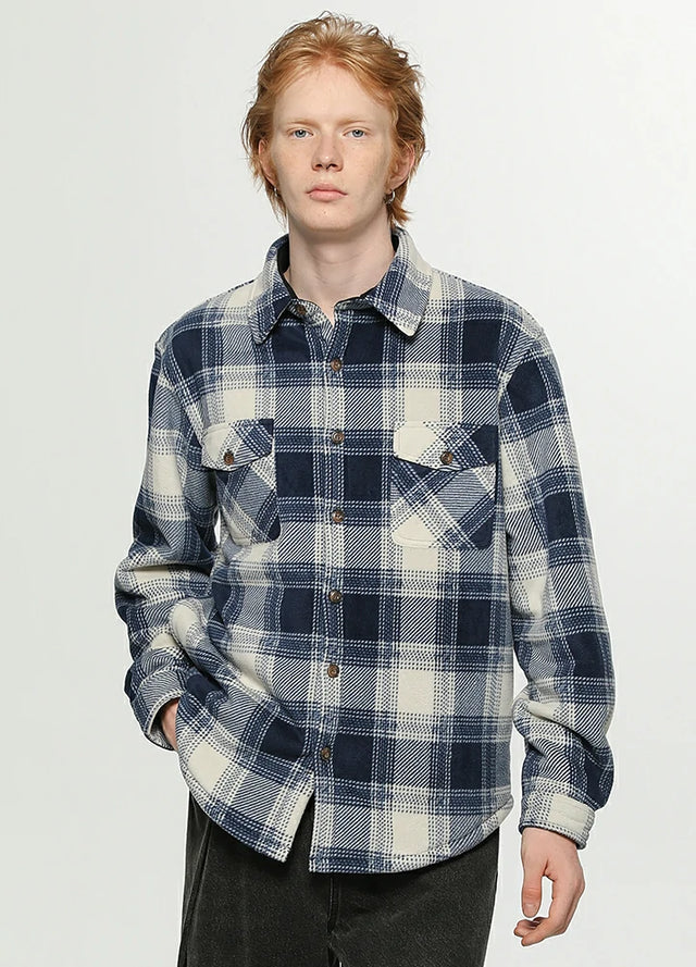 A man in a ocean blue white men's sherpa lined plaid jacket with button closure
