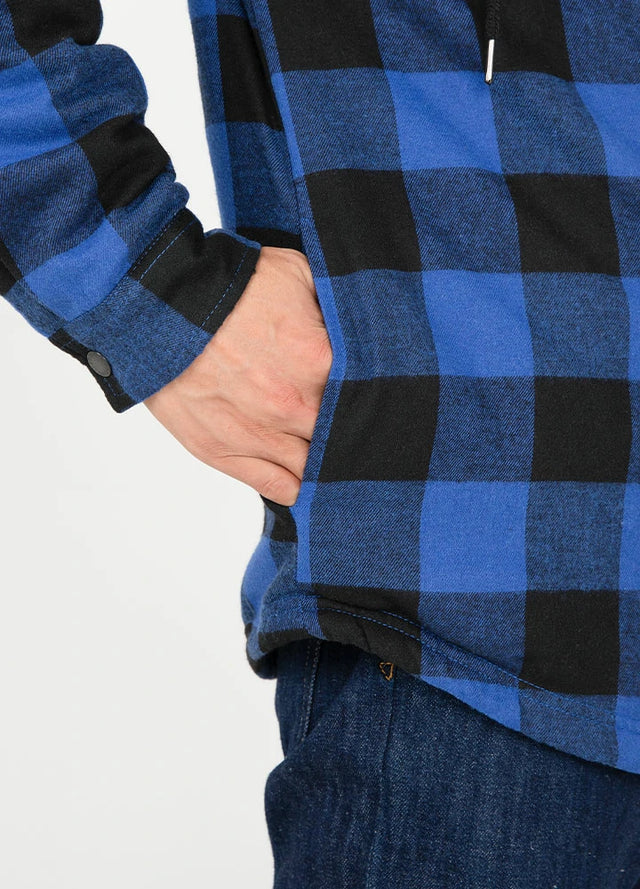 Close-up of the seam pocket of blue black men's sherpa lined flannel jacket with hood