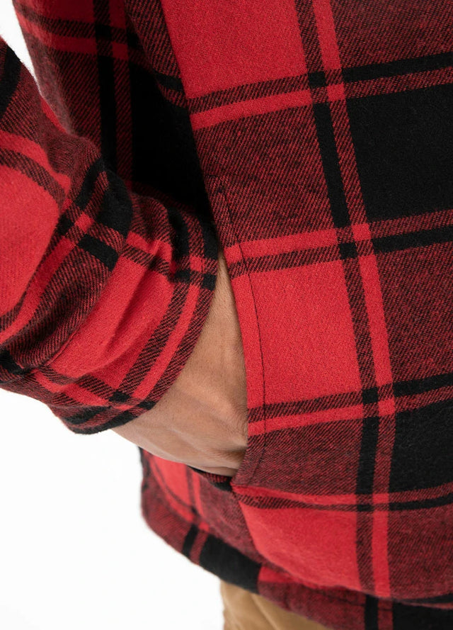 Close-up of a man in red black men's sherpa-lined flannel hooded jacket putting his hand in the seam pocket