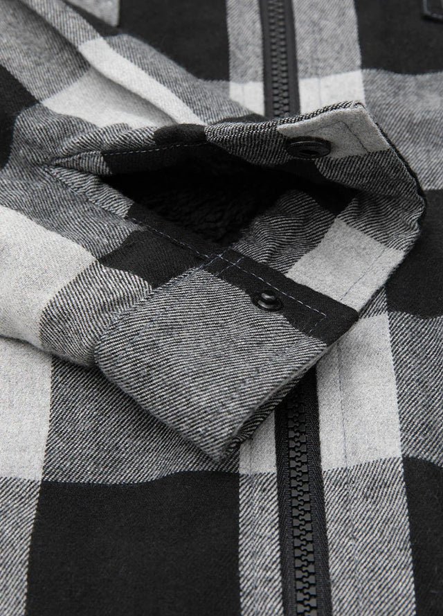 Close-up of the cuff of a gray mens sherpa lined flannel jacket with hood