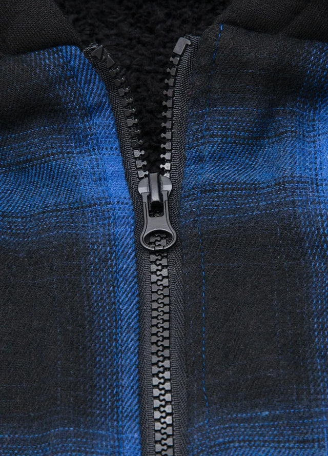 Close-up of the zipper of a blue and black winter flannel plaid hoodie for men