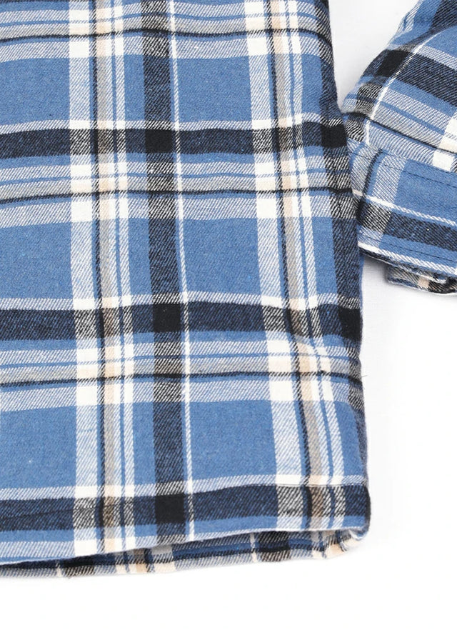 Close-up of the hand pocket of a blue and white cozy quilted lined flannel plaid shacket for men