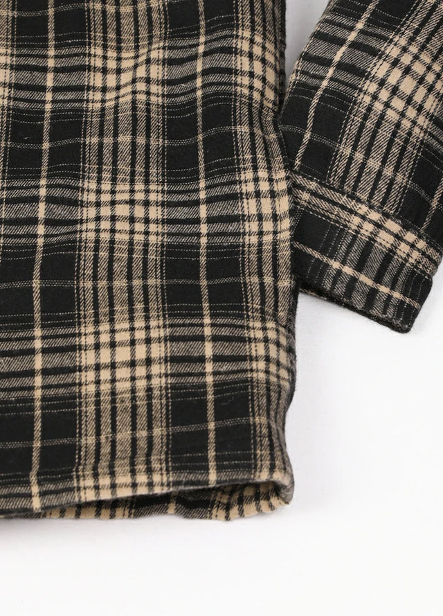 Close-up of the hand pocket of a khaki black cozy quilted lined flannel shacket for men