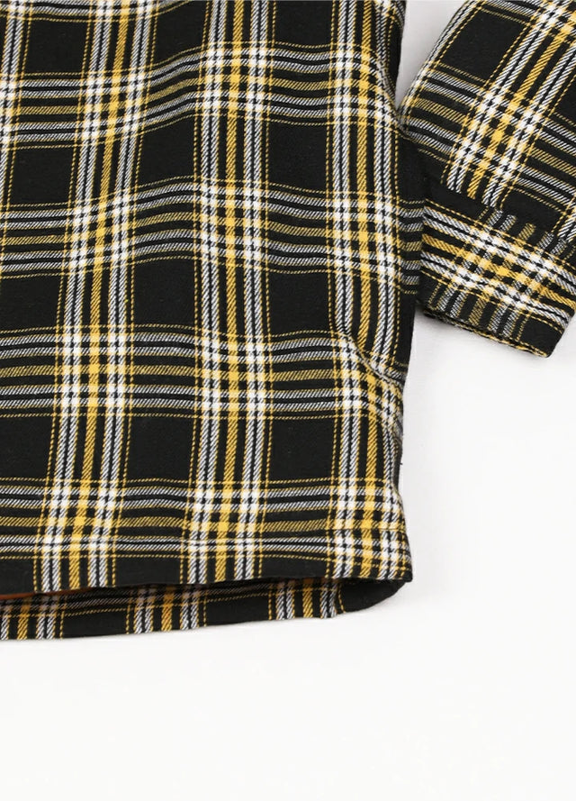 Close-up of the hand pocket of a yellow and black men's plaid hooded shirt jacket with quilted lined