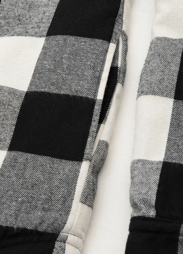Close-up of the seam pocket of black beige men's warm zipper flannel hooded jacket