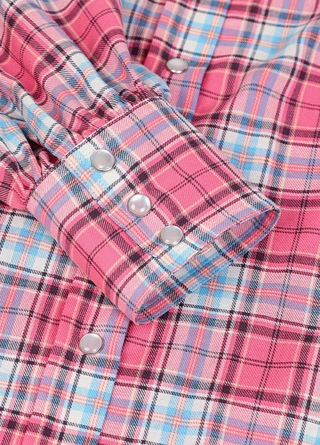 Zoomed-in view of the cuffs on a womens pink flannel shirt dress