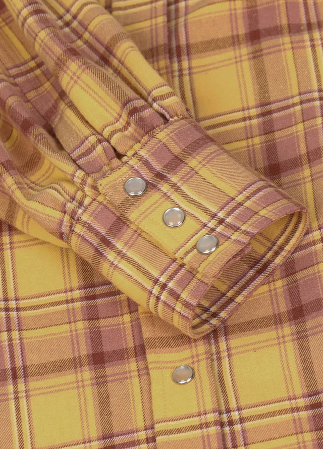 Zoomed-in view of the cuffs on a womens yellow flannel shirt dress