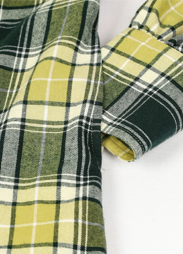 Close-up of women's pearl snap green flannel shirt dress hand pocket