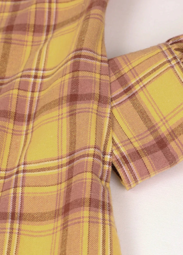 Close-up of women's pearl snap yellow flannel shirt dress hand pocket