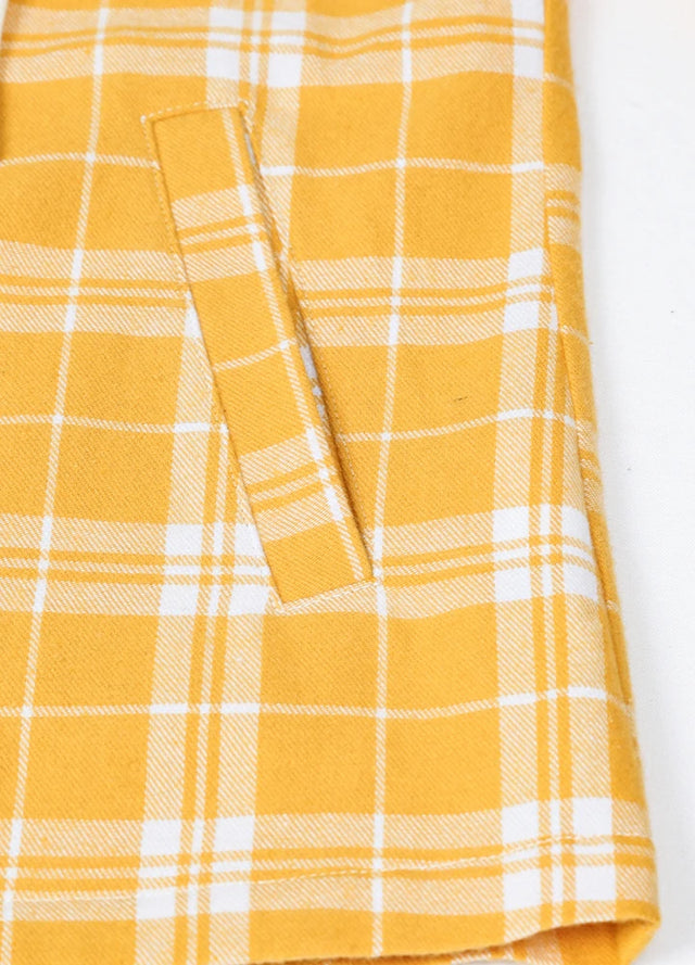 Close-up of the hand pocket on a women's full-zip yellow white flannel hoodie