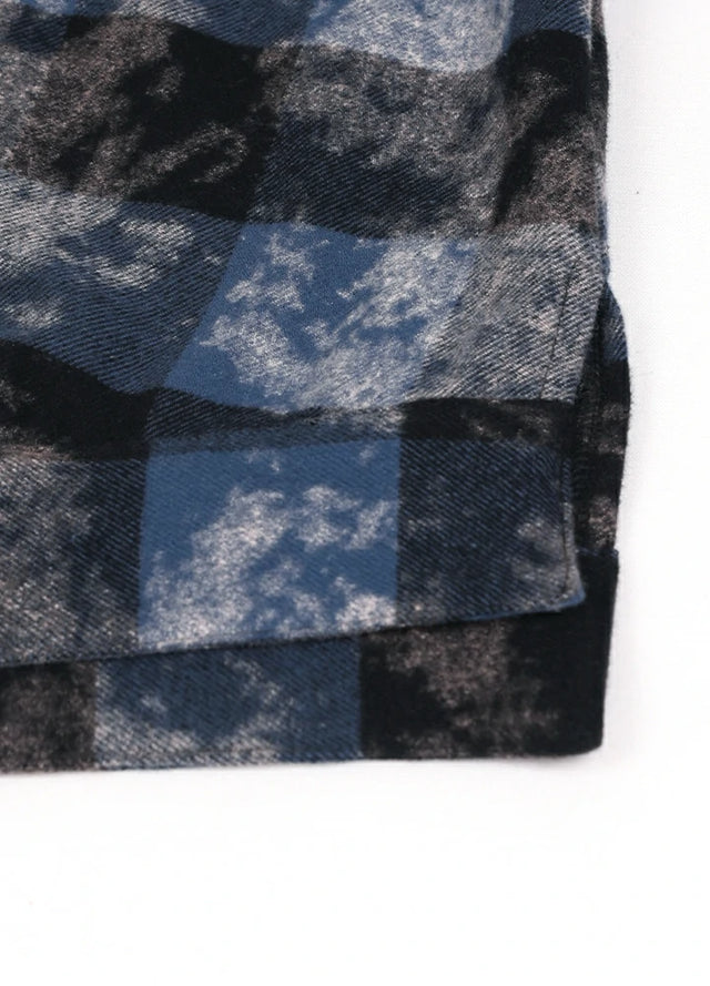 Close-up of the hem on a women's blue black long sleeve plaid shirt
