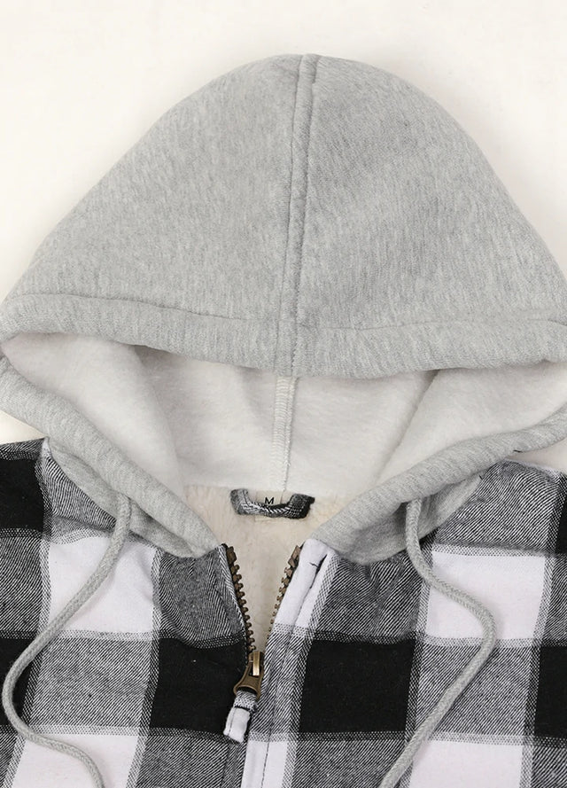 Close-up of the zipper detail on a women's black gray plaid flannel jacket