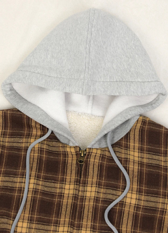 Close-up of the zipper detail on a women's brown plaid flannel jacket