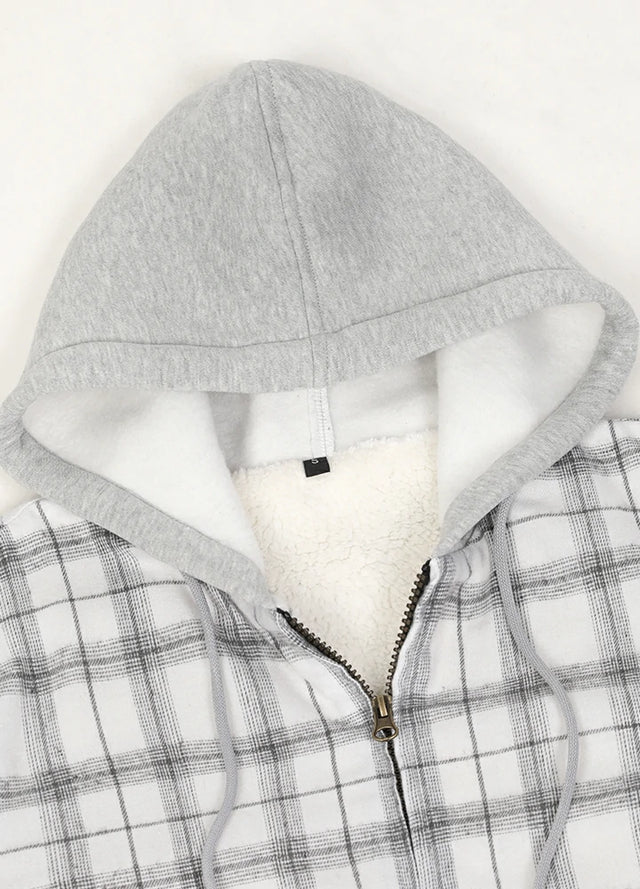 Close-up of the zipper detail on a women's white plaid flannel jacket