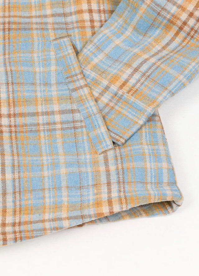 Close-up of womens sherpa-lined blue yellow flannel hooded hand pocket
