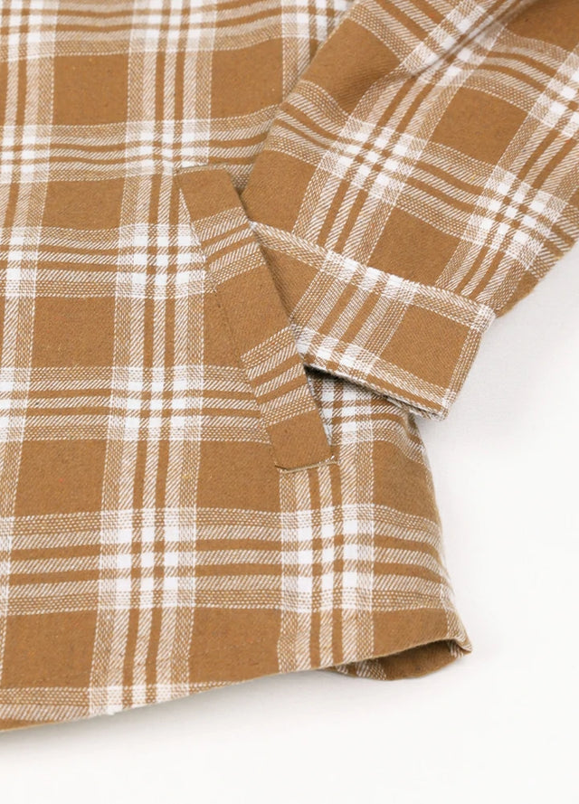 Close-up of womens sherpa-lined brown flannel hooded hand pocket