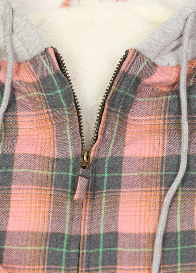 Close-up of the zipper detail on a women's pink plaid flannel jacket