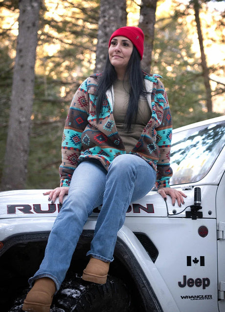 Women in a brown blue sherpa lined aztec fleece shacket with button