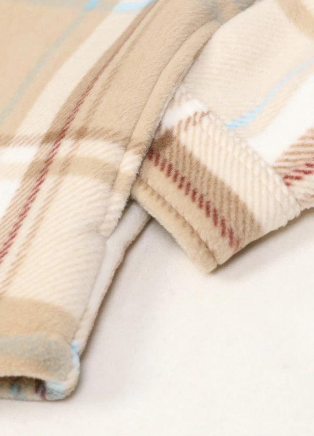 Close-up of a womens sherpa lined cream fleece shacket hand pocket